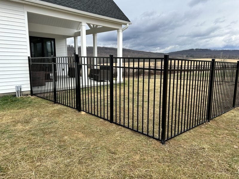 Black aluminum fence around house